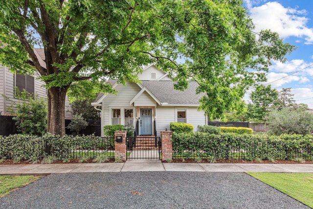 1202 Ashland St, Houston, TX 77008 - view of front of home featuring roof with shingles, a fenced front yard, and a gate