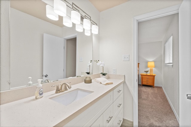 bathroom with vanity and baseboards