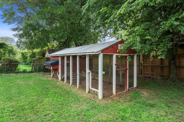 view of poultry coop with fence and a yard