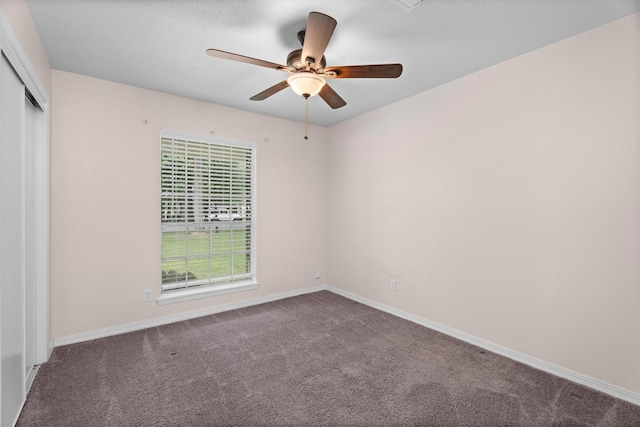unfurnished room with baseboards, ceiling fan, and carpet flooring