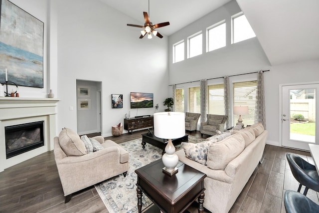 2242 Bayleaf Manor Dr, Manvel, TX 77578 - living room featuring a glass covered fireplace, dark wood-style floors, and high vaulted ceiling