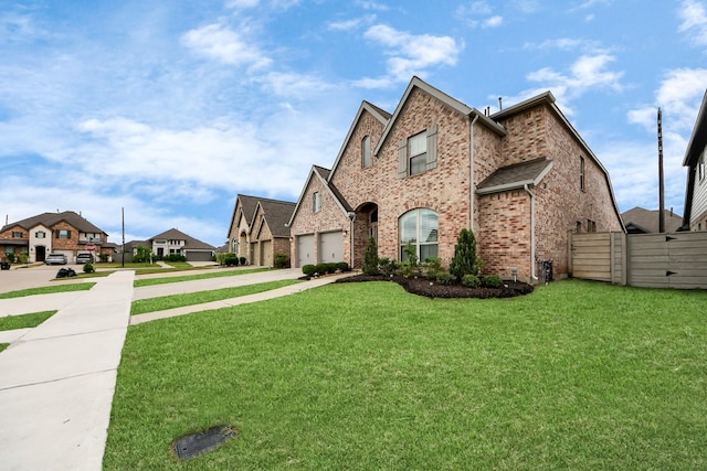 2242 Bayleaf Manor Dr, Manvel, TX 77578 - view of front of property with fence, a front yard, brick siding, concrete driveway, and a residential view