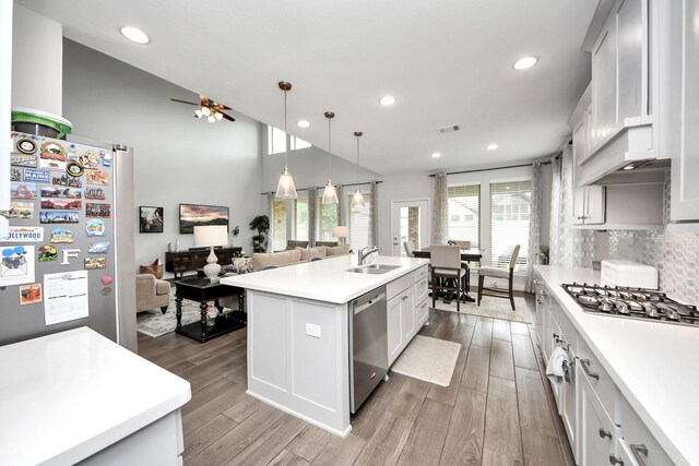 2242 Bayleaf Manor Dr, Manvel, TX 77578 - kitchen with light countertops, a sink, wood finished floors, and stainless steel appliances