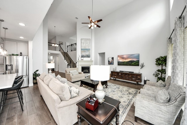 2242 Bayleaf Manor Dr, Manvel, TX 77578 - living area featuring a towering ceiling, dark wood-style floors, stairway, recessed lighting, and a ceiling fan