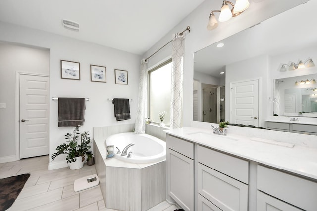 2242 Bayleaf Manor Dr, Manvel, TX 77578 - full bath featuring visible vents, vanity, a garden tub, baseboards, and a shower stall