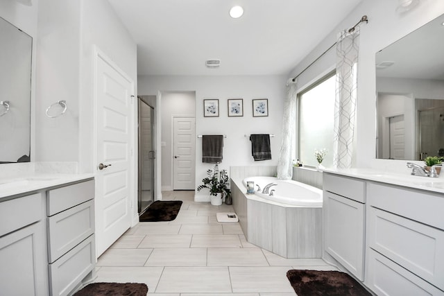 2242 Bayleaf Manor Dr, Manvel, TX 77578 - bathroom featuring two vanities, a shower stall, a sink, and a bath