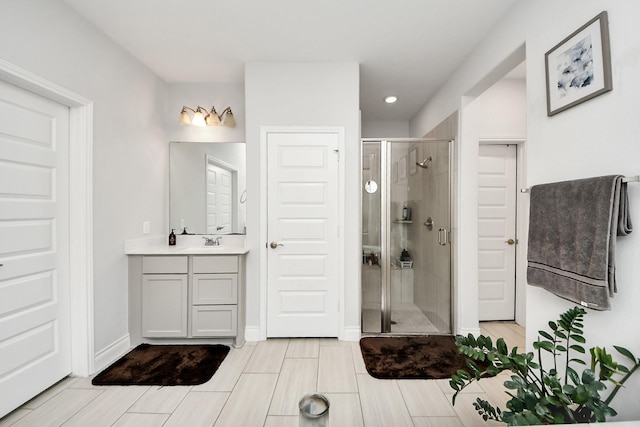 2242 Bayleaf Manor Dr, Manvel, TX 77578 - bathroom featuring vanity, baseboards, a shower stall, and recessed lighting