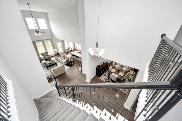 2242 Bayleaf Manor Dr, Manvel, TX 77578 - stairway with baseboards, a high ceiling, ceiling fan with notable chandelier, and wood finished floors