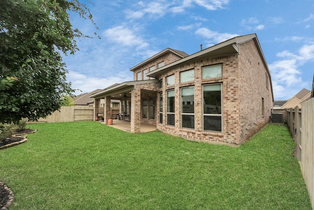 2242 Bayleaf Manor Dr, Manvel, TX 77578 - back of house with brick siding, a fenced backyard, a patio area, and a lawn