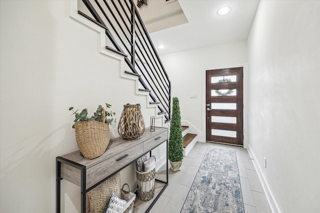 foyer with stairway and recessed lighting