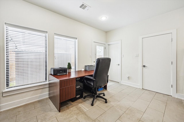 home office featuring baseboards, visible vents, and light tile patterned floors