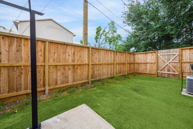 view of yard featuring cooling unit and a fenced backyard