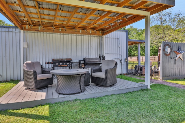 1315 Kilgore Rd, Baytown, TX 77520 - wooden terrace featuring fence, an outdoor structure, a lawn, and area for grilling