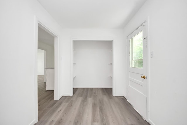 206 Hill St, Dayton, TX 77535 - hallway featuring baseboards and light wood-type flooring