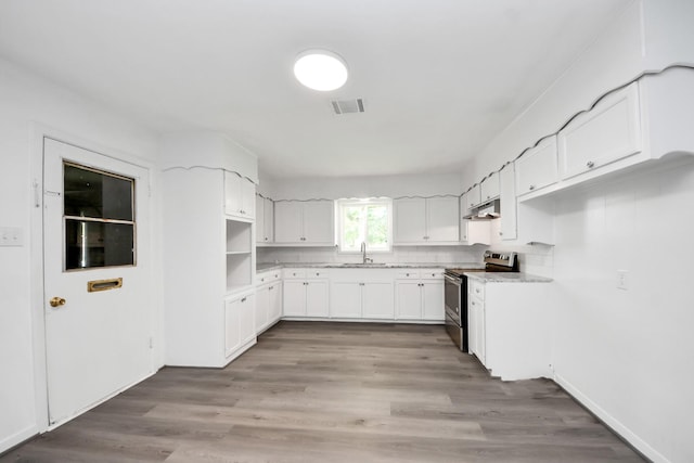 206 Hill St, Dayton, TX 77535 - kitchen featuring white cabinets, a sink, visible vents, under cabinet range hood, and electric range