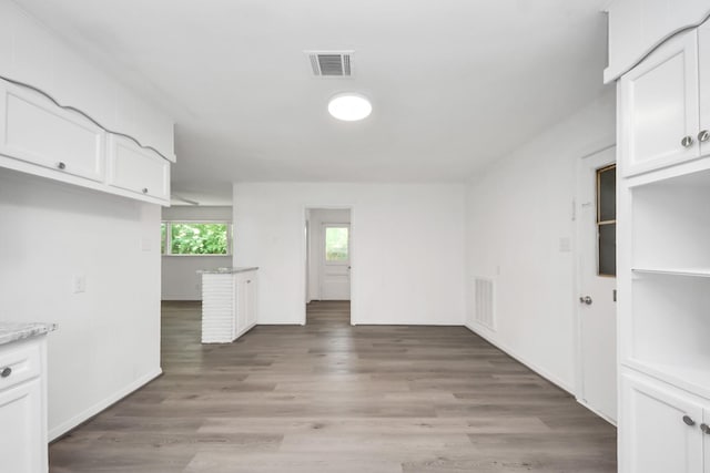 206 Hill St, Dayton, TX 77535 - interior space featuring visible vents, light wood-style flooring, and white cabinetry