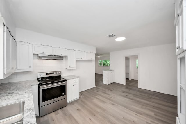 206 Hill St, Dayton, TX 77535 - kitchen with white cabinets, light wood-style floors, electric range, and under cabinet range hood