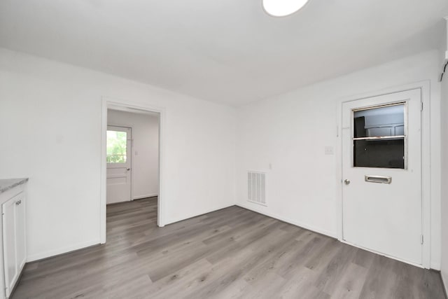 206 Hill St, Dayton, TX 77535 - unfurnished room featuring visible vents, baseboards, and light wood-type flooring