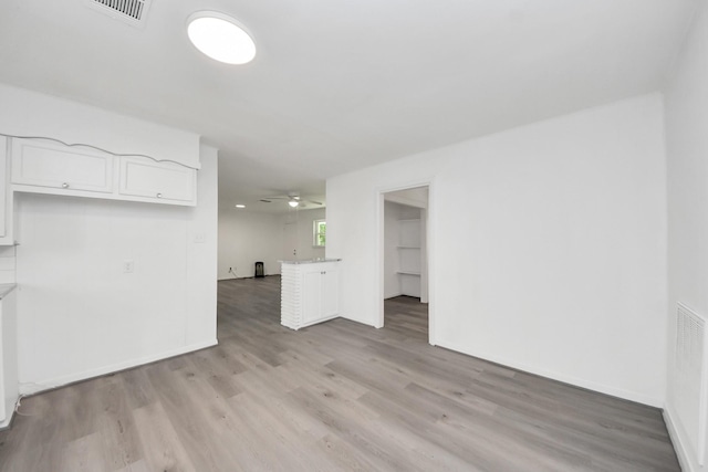 206 Hill St, Dayton, TX 77535 - unfurnished living room featuring visible vents, light wood-type flooring, ceiling fan, and baseboards