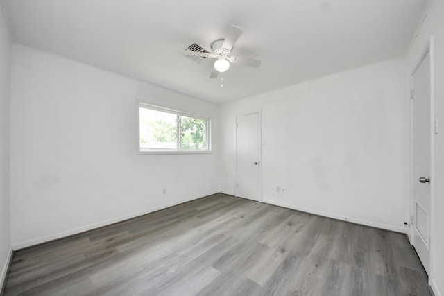 206 Hill St, Dayton, TX 77535 - spare room with baseboards, visible vents, wood finished floors, and a ceiling fan