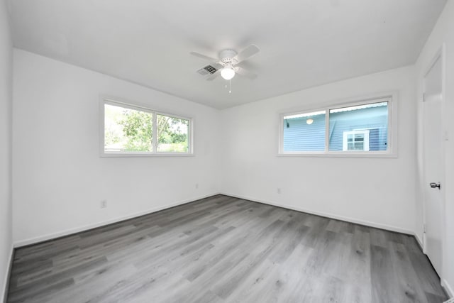 206 Hill St, Dayton, TX 77535 - empty room featuring wood finished floors, visible vents, ceiling fan, and baseboards