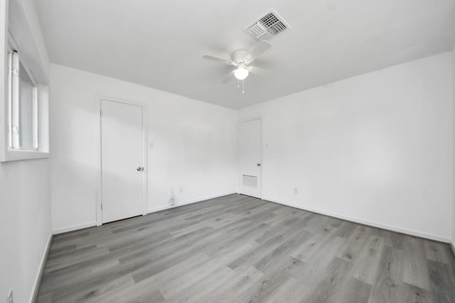 206 Hill St, Dayton, TX 77535 - spare room with baseboards, visible vents, wood finished floors, and ceiling fan