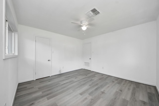 206 Hill St, Dayton, TX 77535 - spare room with baseboards, visible vents, wood finished floors, and a ceiling fan