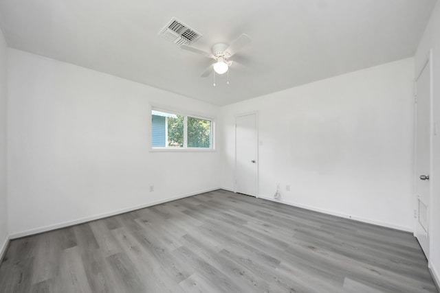 206 Hill St, Dayton, TX 77535 - spare room with baseboards, visible vents, wood finished floors, and ceiling fan