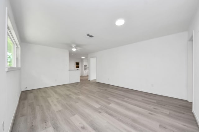 206 Hill St, Dayton, TX 77535 - unfurnished living room featuring light wood-style floors, a ceiling fan, visible vents, and baseboards