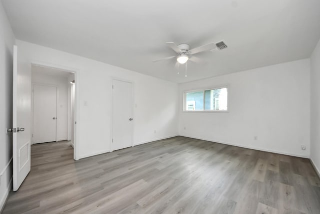 206 Hill St, Dayton, TX 77535 - unfurnished bedroom featuring baseboards, visible vents, a ceiling fan, and light wood-style flooring