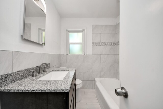 206 Hill St, Dayton, TX 77535 - full bathroom with tile walls, toilet, tile patterned flooring, and vanity
