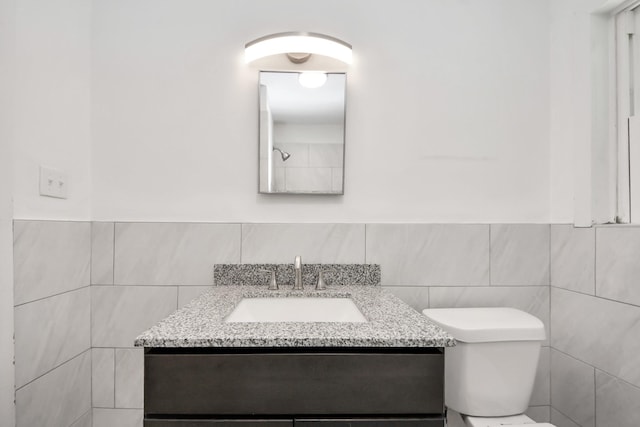 206 Hill St, Dayton, TX 77535 - bathroom featuring vanity, toilet, a wainscoted wall, and tile walls