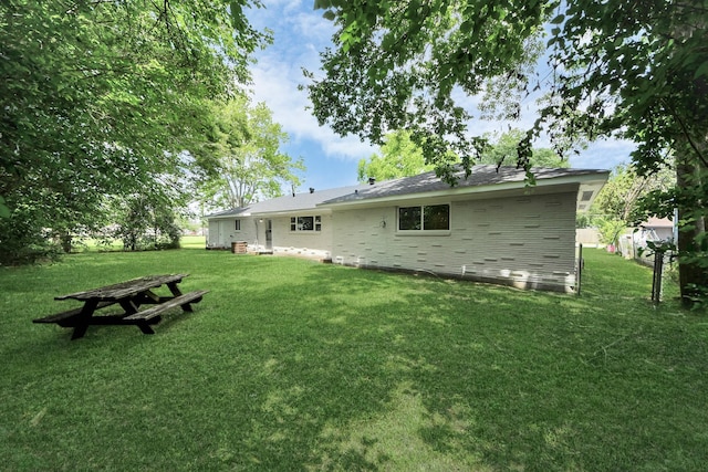 206 Hill St, Dayton, TX 77535 - rear view of house featuring a yard