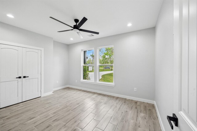 unfurnished bedroom with recessed lighting, light wood-style flooring, a closet, baseboards, and visible vents
