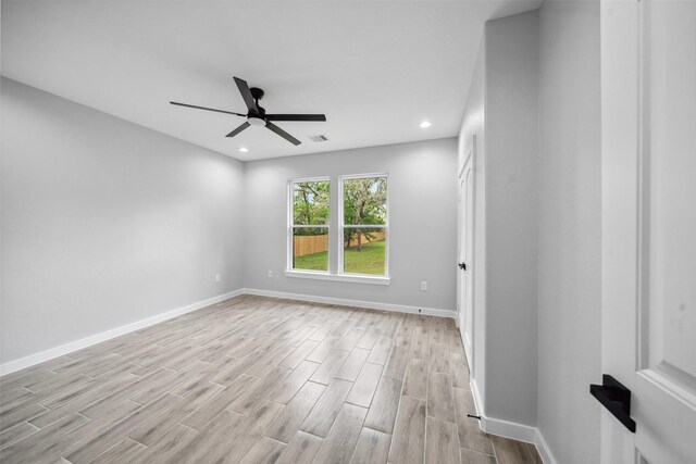 spare room with light wood-style floors, visible vents, baseboards, recessed lighting, and a ceiling fan