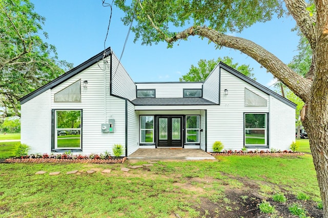 back of house featuring french doors and a yard