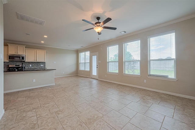 unfurnished living room with visible vents, ceiling fan, crown molding, and baseboards