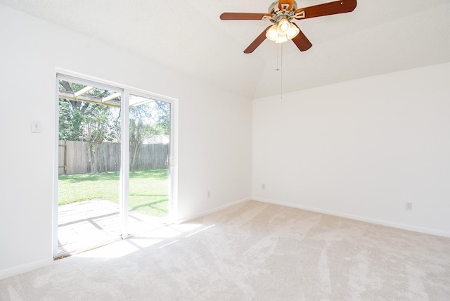 empty room with a ceiling fan, carpet flooring, vaulted ceiling, and baseboards