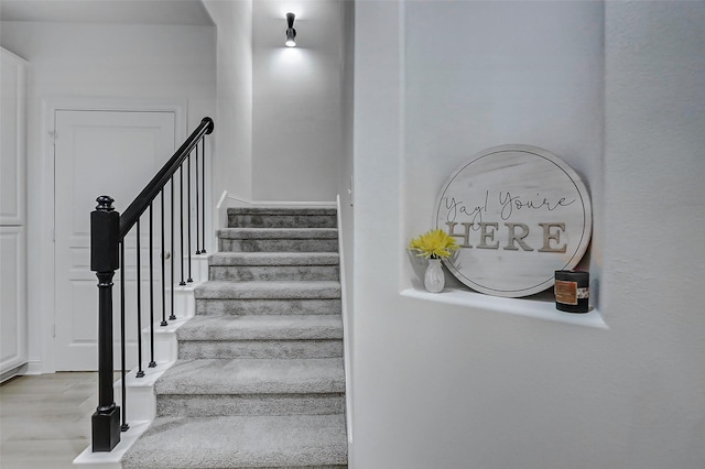 stairway with wood finished floors