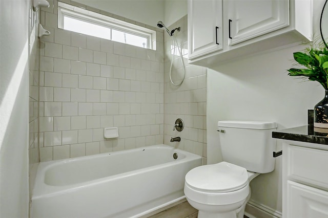 bathroom featuring shower / bathing tub combination, vanity, and toilet