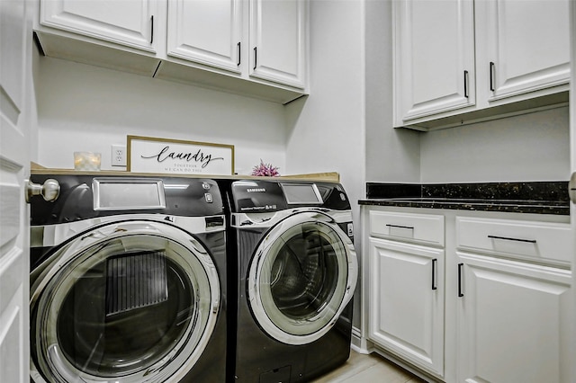 clothes washing area with washer and dryer and cabinet space