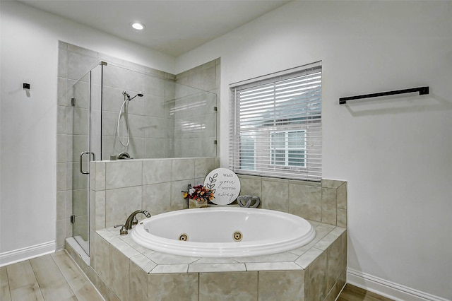 bathroom with a jetted tub, recessed lighting, a stall shower, and baseboards