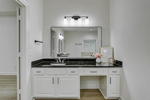 bathroom featuring wood finished floors and vanity