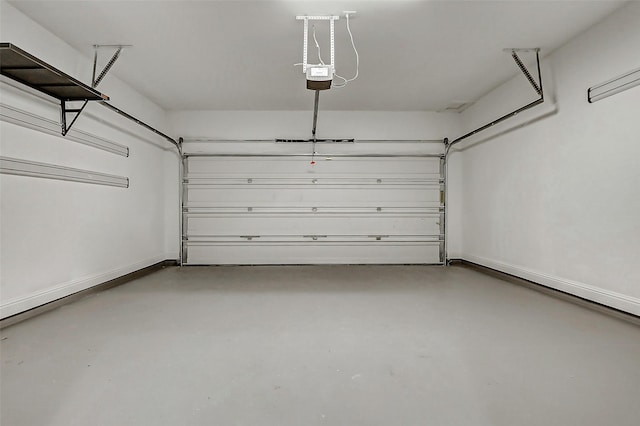 garage featuring a garage door opener and baseboards