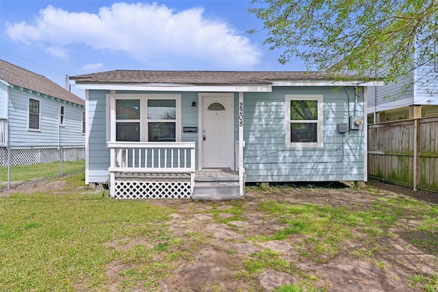 2208 Victory St, Galveston, TX 77551 - view of front of home with fence, covered porch, and a front yard