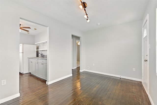 2208 Victory St, Galveston, TX 77551 - interior space with dark wood finished floors, baseboards, ceiling fan, and a sink