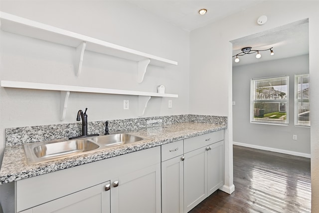 2208 Victory St, Galveston, TX 77551 - kitchen featuring a sink, dark wood-style flooring, open shelves, baseboards, and white cabinets