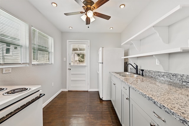 2208 Victory St, Galveston, TX 77551 - kitchen with dark wood finished floors, white appliances, open shelves, ceiling fan, and a sink