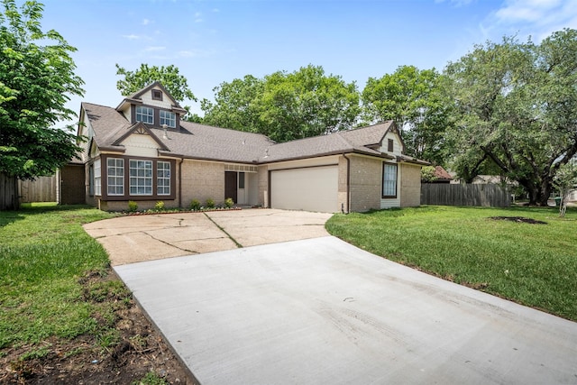 11915 Green Glade Dr, Houston, TX 77099 - view of front facade featuring brick siding, fence, a front yard, concrete driveway, and an attached garage