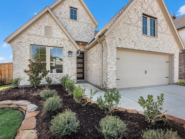 4203 Chloe Ridge Ln, Fulshear, TX 77441 - french provincial home with driveway, fence, brick siding, and a garage